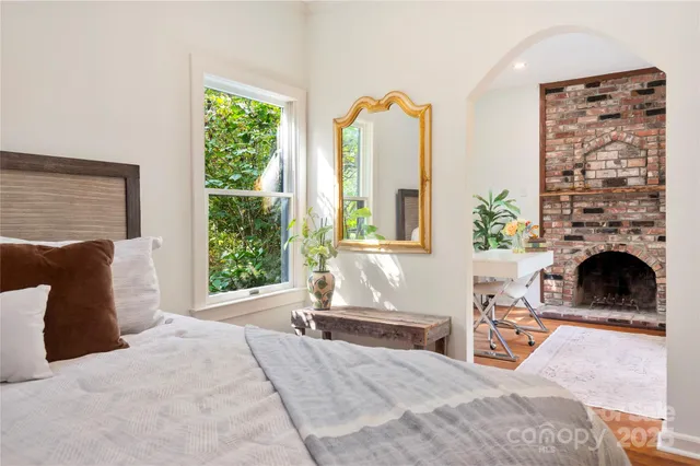 a living room with furniture large window and a fireplace