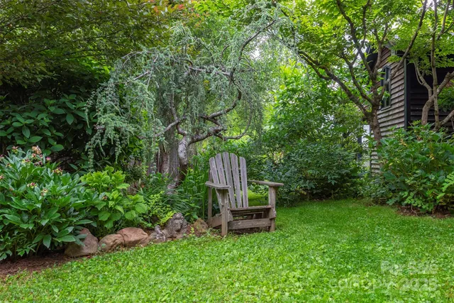 a wooden bench sitting in the middle of a garden