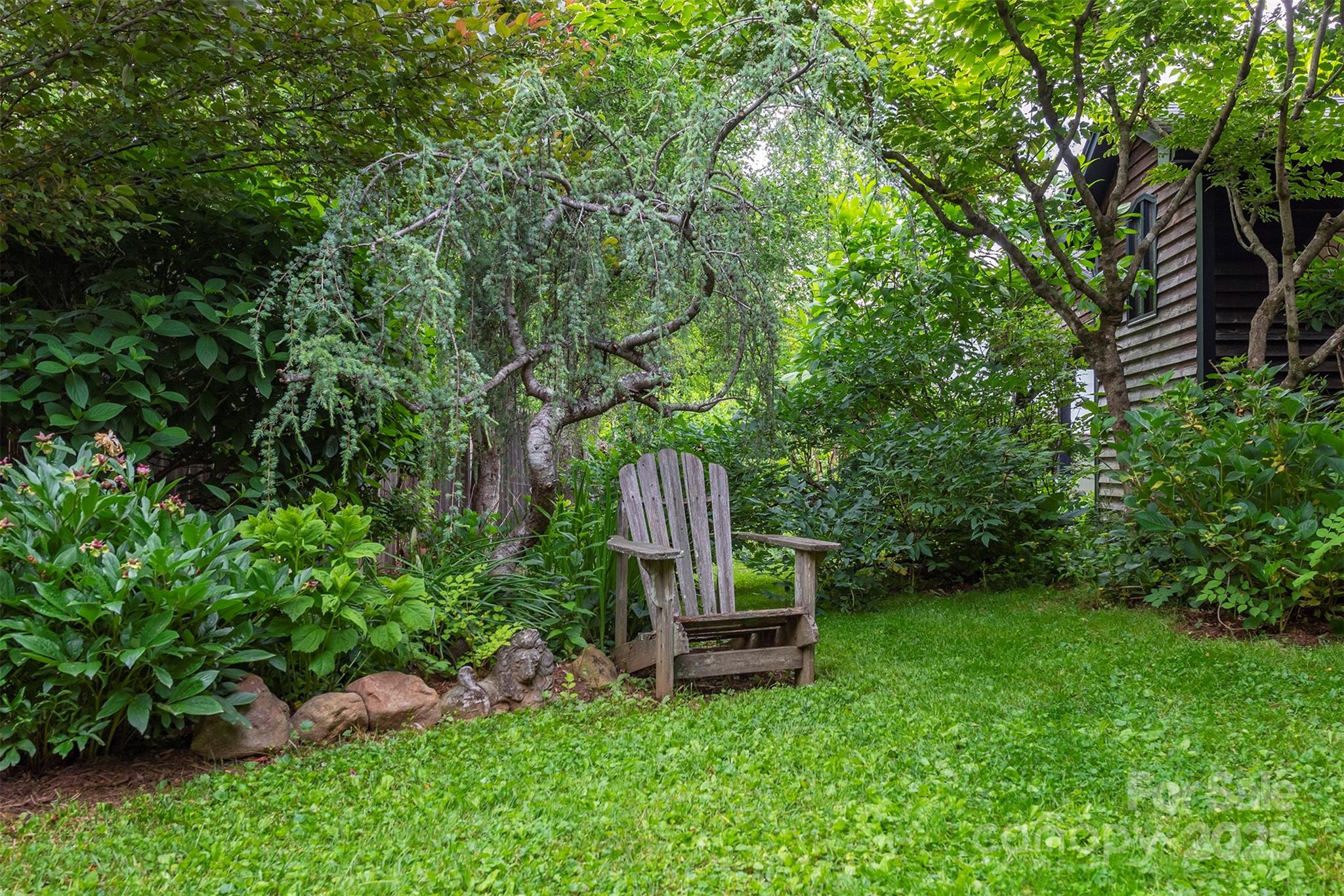 528 Padgettown Road Black Mountain, NC 28711 - Photo 17 of 43 a wooden bench sitting in the middle of a garden