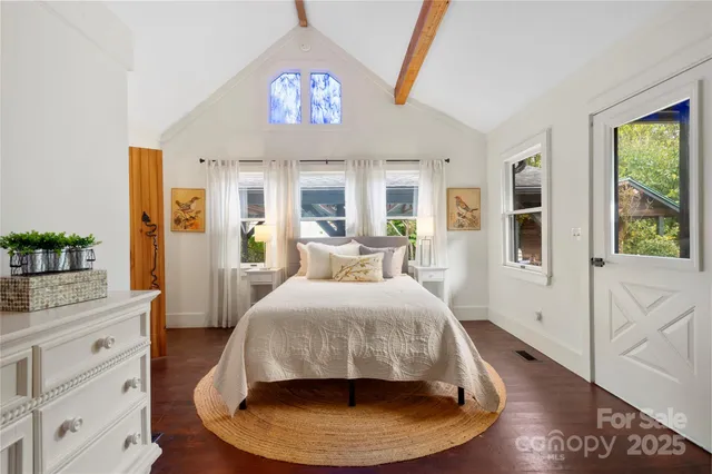 a bed room with a bed and a chandelier