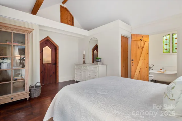 a bedroom with a bed and a mirror