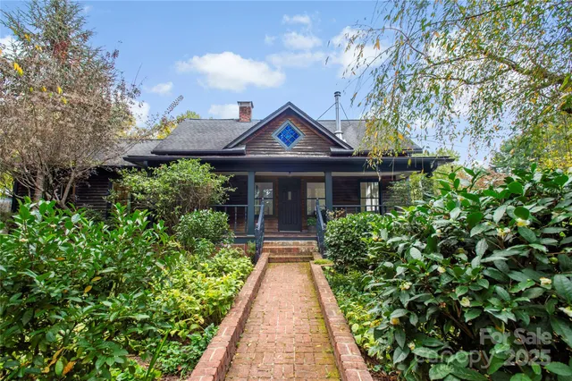 a view of house with backyard