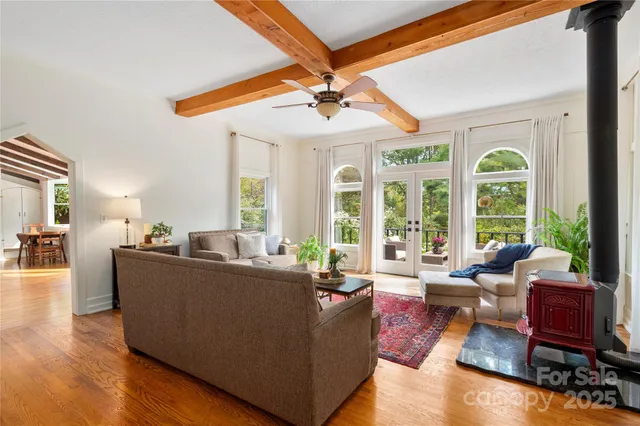 a living room with furniture and large windows