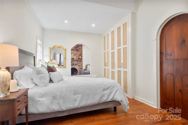 a spacious bedroom with a bed and a window