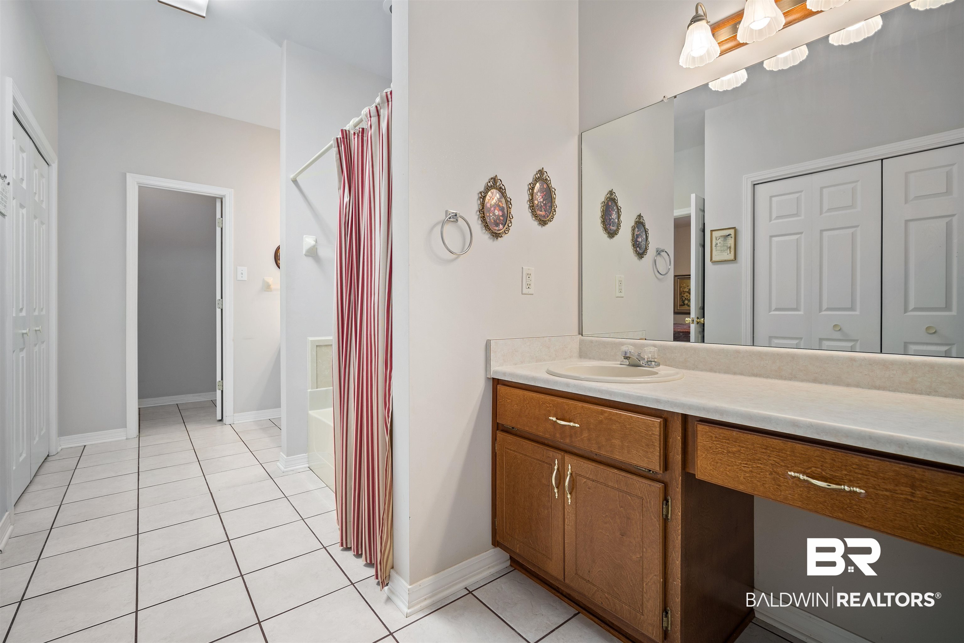 7419 Pake Road Saraland, AL 36571 - Photo 16 of 27 Bathroom featuring tile patterned flooring and vanity