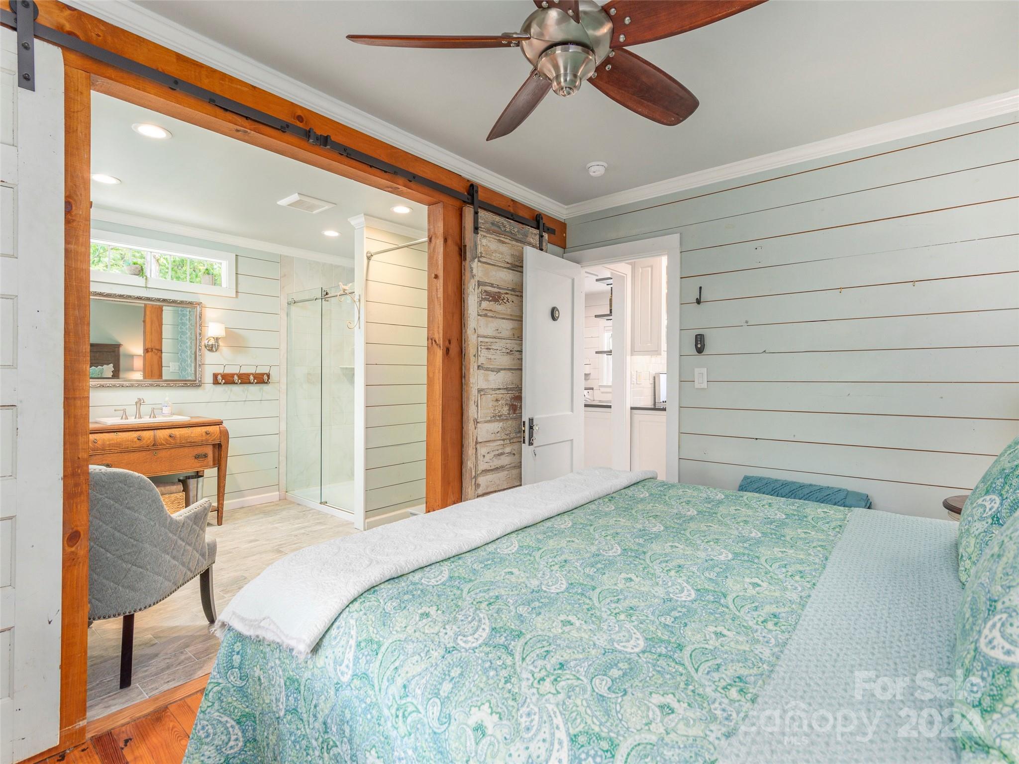 952 Thompson Cove Road Clyde, NC 28721 - Photo 17 of 43 a spacious bedroom with a bed and a chandelier