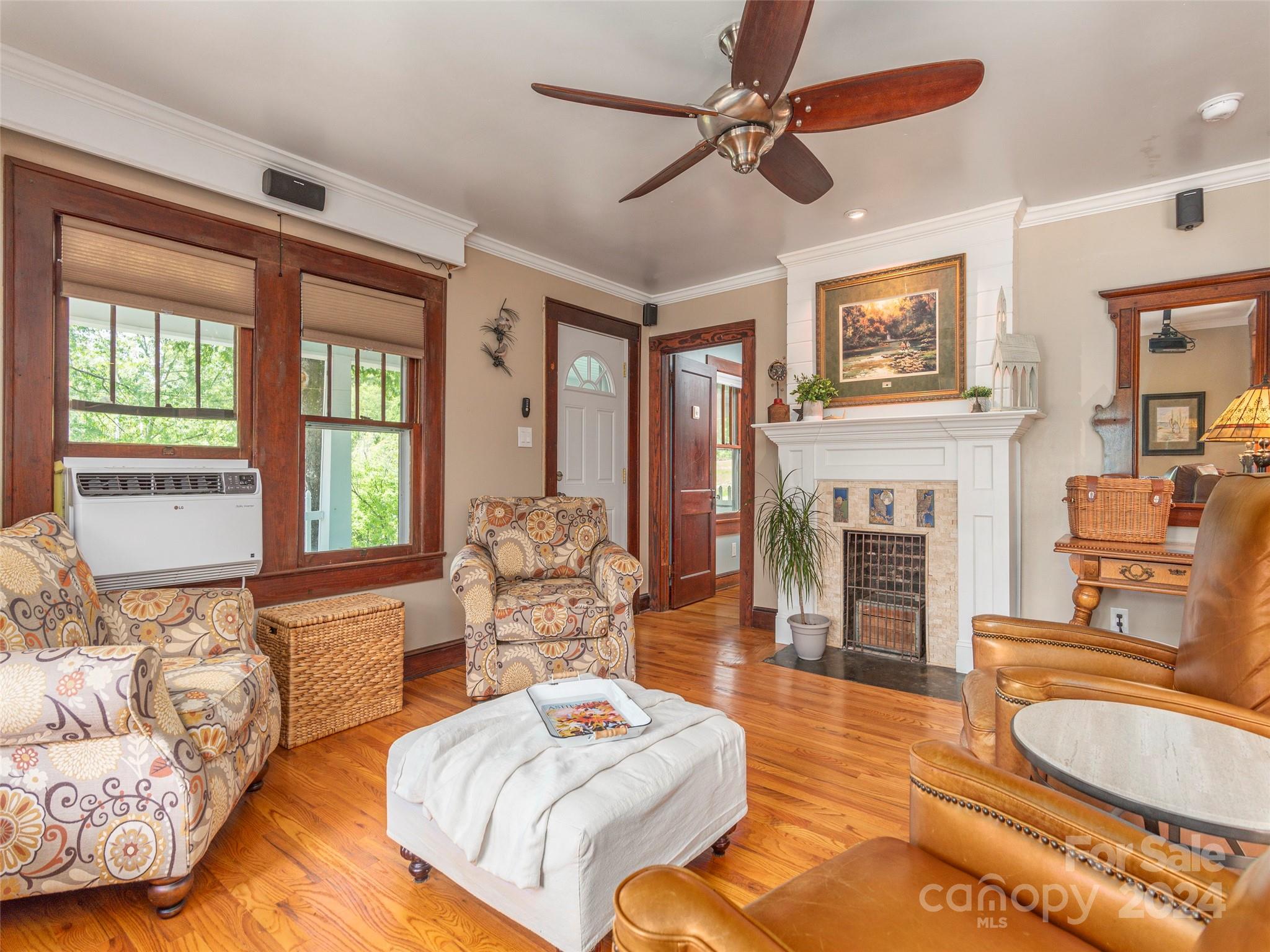 952 Thompson Cove Road Clyde, NC 28721 - Photo 7 of 43 a living room with fireplace furniture and a wooden floor