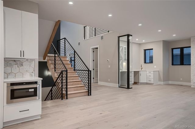 a view of a livingroom with furniture and stairs
