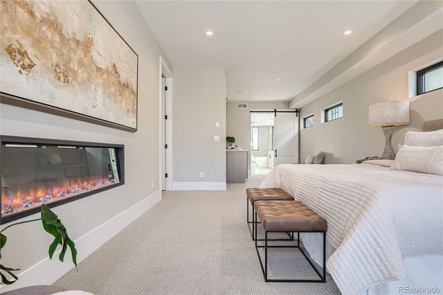 a bedroom with a bed and a television on the dresser