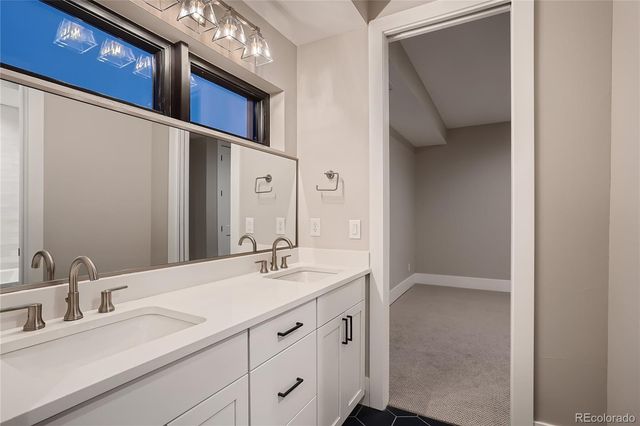 a bathroom with a double vanity sink and mirror