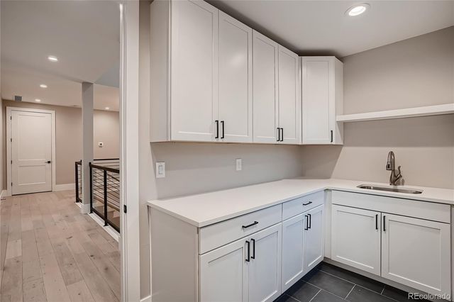 a kitchen with a sink cabinets and appliances