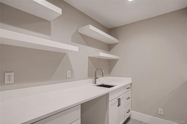a kitchen with a sink and cabinets