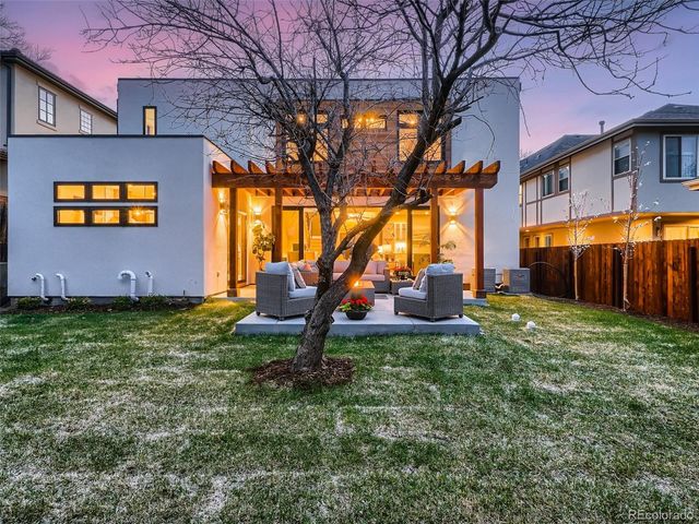 a view of patio with couches and a fire pit