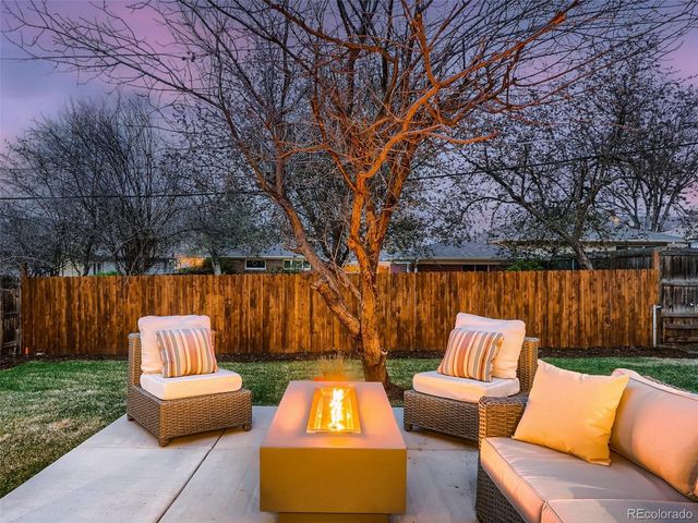 a view of a porch with wooden floor and iron stairs