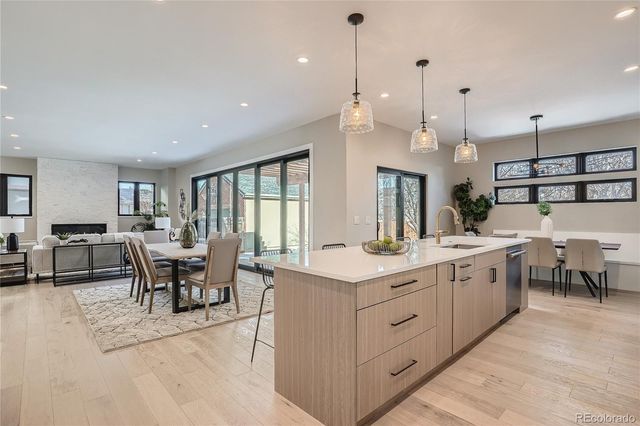 a large kitchen with kitchen island a sink a dining table and chairs