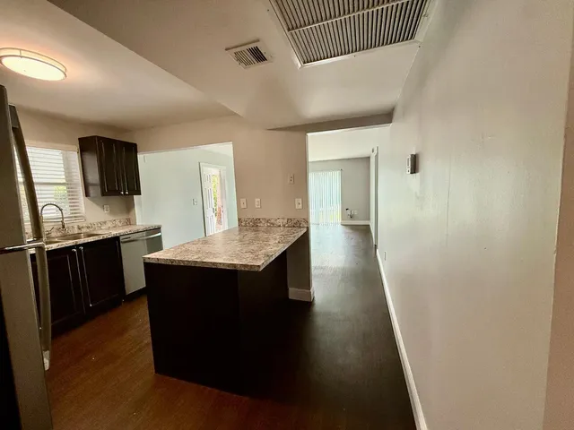 a kitchen with kitchen island sink refrigerator and stove