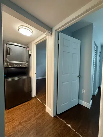 a view of a kitchen with an empty space wooden floor and a kitchen