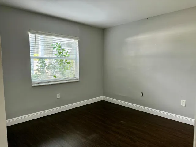 a view of a room with wooden floor and windows