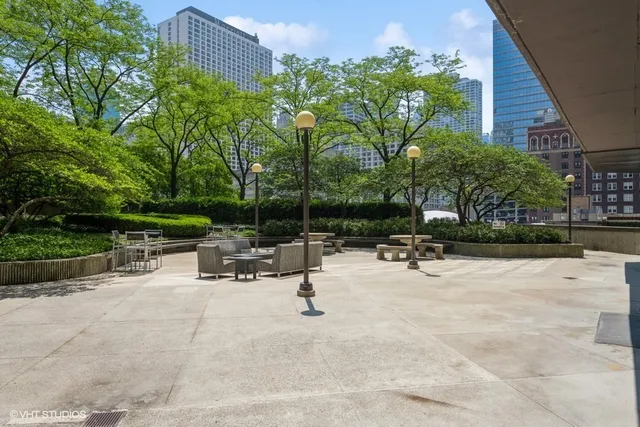 a view of backyard with plants and outdoor seating