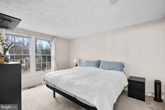 a bedroom with a large bed and a large window