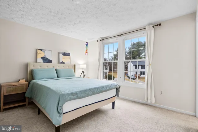 a spacious bedroom with a bed and a window