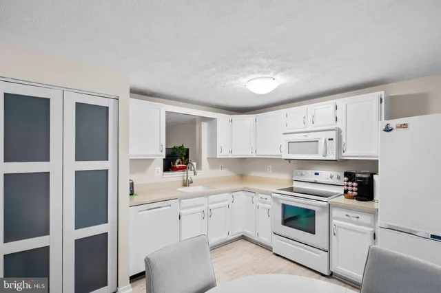 a kitchen with cabinets stainless steel appliances and a counter space