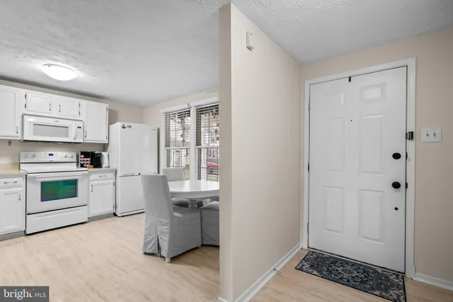 a kitchen with granite countertop a stove and a refrigerator