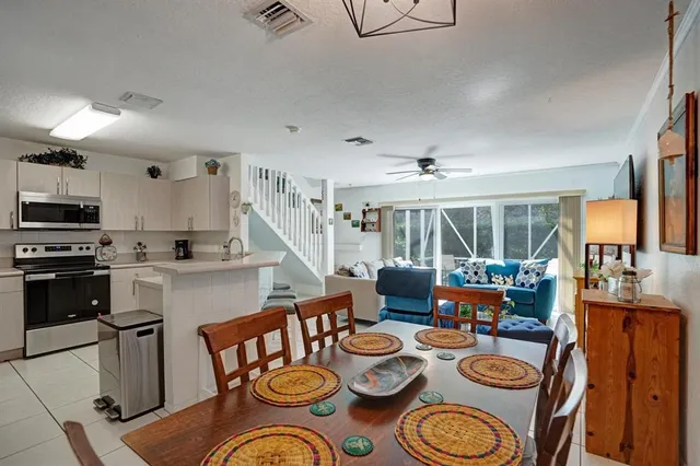 a kitchen with stainless steel appliances a refrigerator sink and microwave