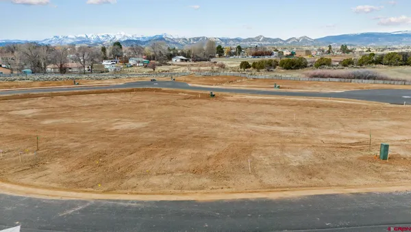 a view of an houses with yard and ocean view