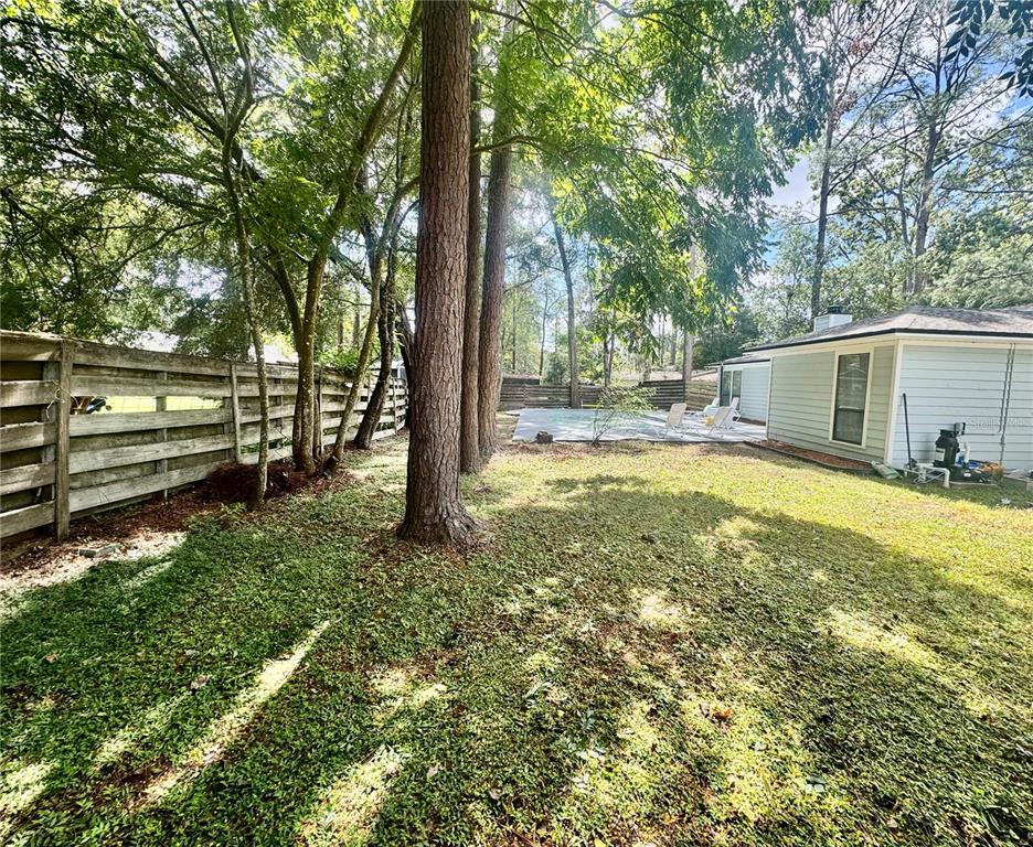 5407 Southwest 82 Terrace Gainesville, FL 32608 - Photo 29 of 31 a view of a house with backyard and trees