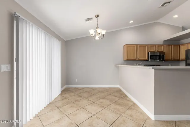 a kitchen with stainless steel appliances granite countertop a refrigerator stove and sink