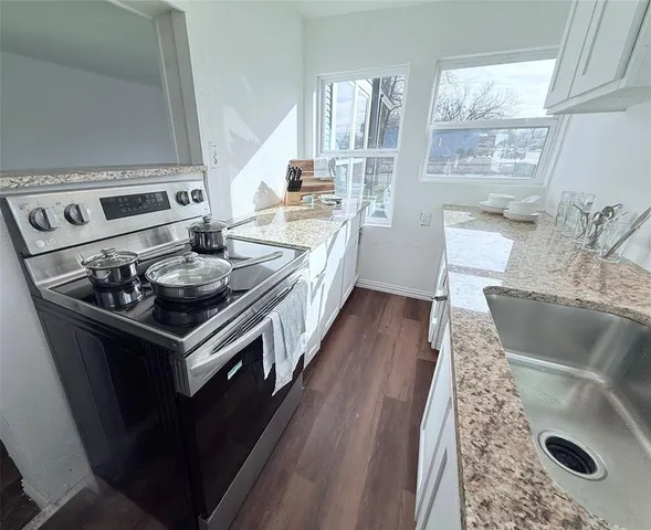a kitchen with stainless steel appliances granite countertop a stove and a sink