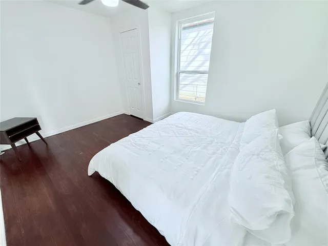 a large bed sitting in a bedroom next to a window