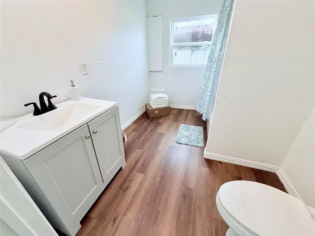 a view of walk in closet with wooden floor