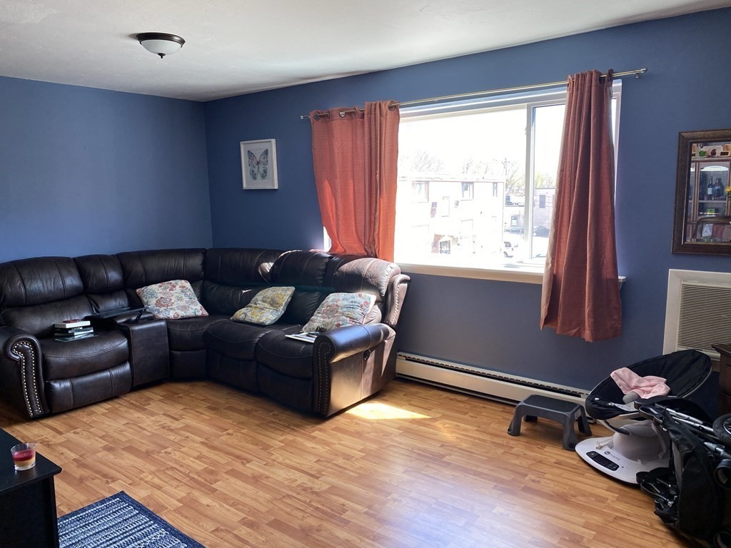 79 Nicholas Road, Unit J Framingham, MA 01701 - Photo 12 of 29 a living room with furniture and a window