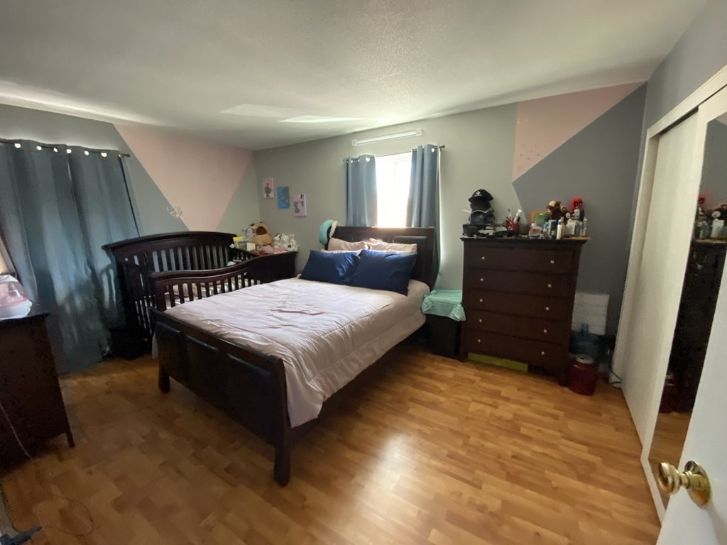 79 Nicholas Road, Unit J Framingham, MA 01701 - Photo 15 of 29 a bedroom with a bed and a closet with mirror