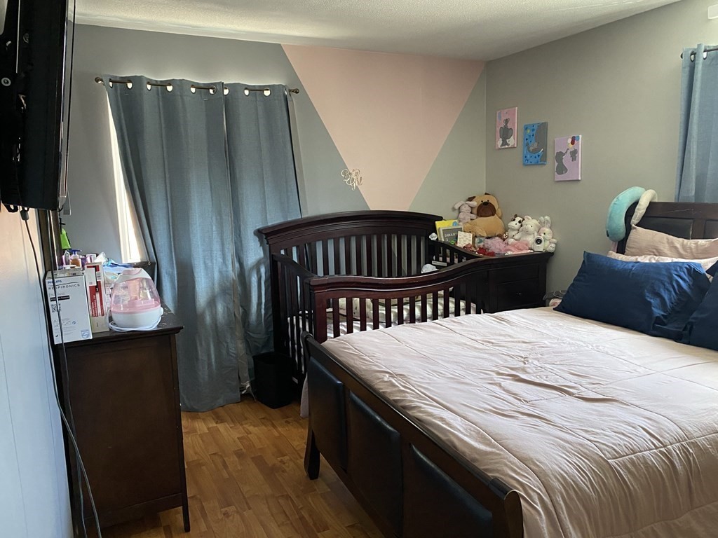 79 Nicholas Road, Unit J Framingham, MA 01701 - Photo 18 of 29 a bedroom with a bed and a window