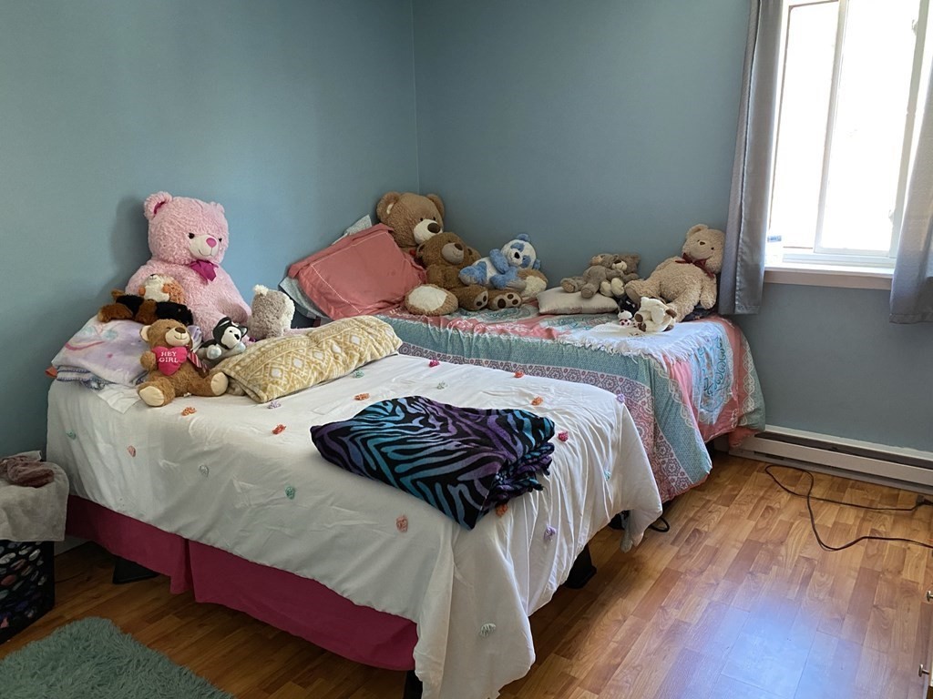 79 Nicholas Road, Unit J Framingham, MA 01701 - Photo 22 of 29 a bedroom with two bed and a window