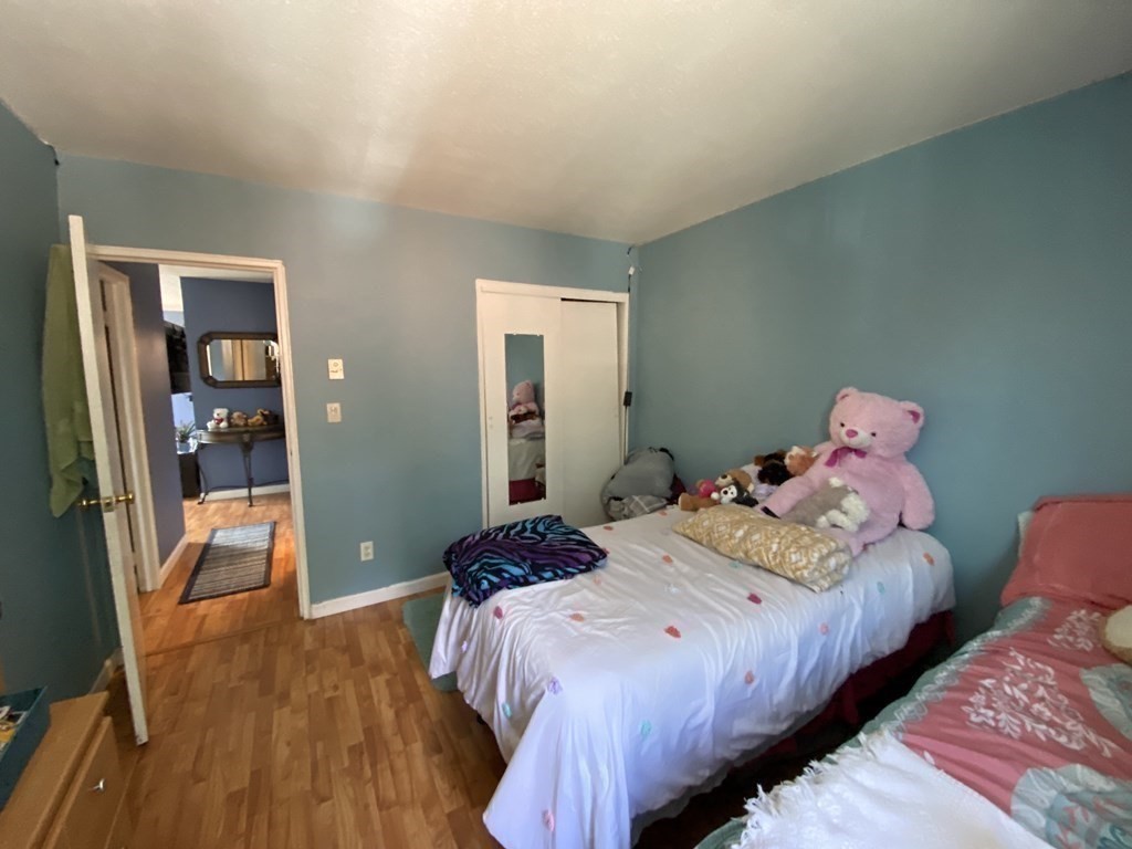 79 Nicholas Road, Unit J Framingham, MA 01701 - Photo 24 of 29 a bedroom with bed and wooden floor