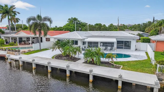 a aerial view of a house with a yard and potted plants