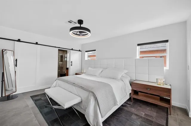 a bedroom with a bed and a chandelier