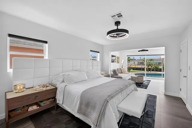 a bedroom with a bed and a large window