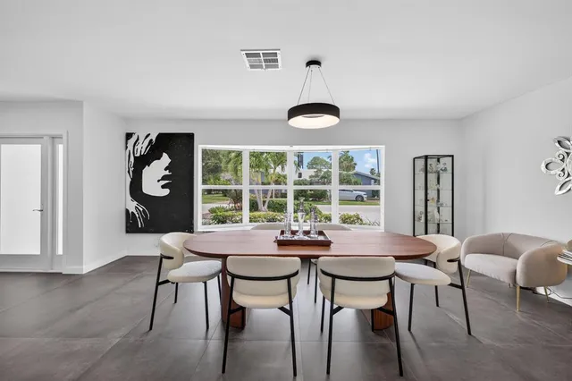 a view of a dining room with furniture and a chandelier