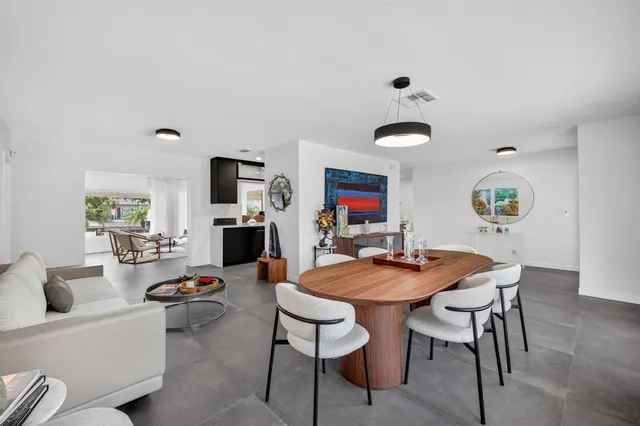 a view of a dining room with furniture and a chandelier