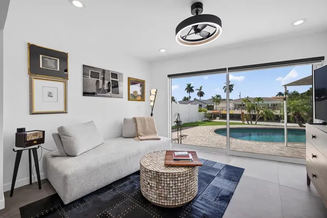 a view of swimming pool with outdoor seating and plants
