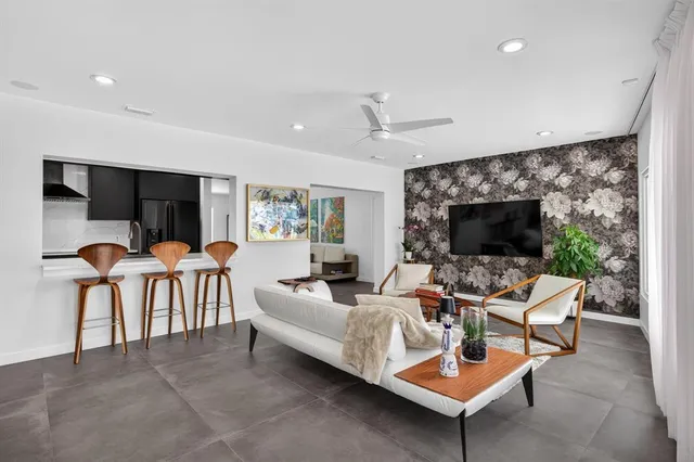 a living room with furniture a flat screen tv and a fireplace