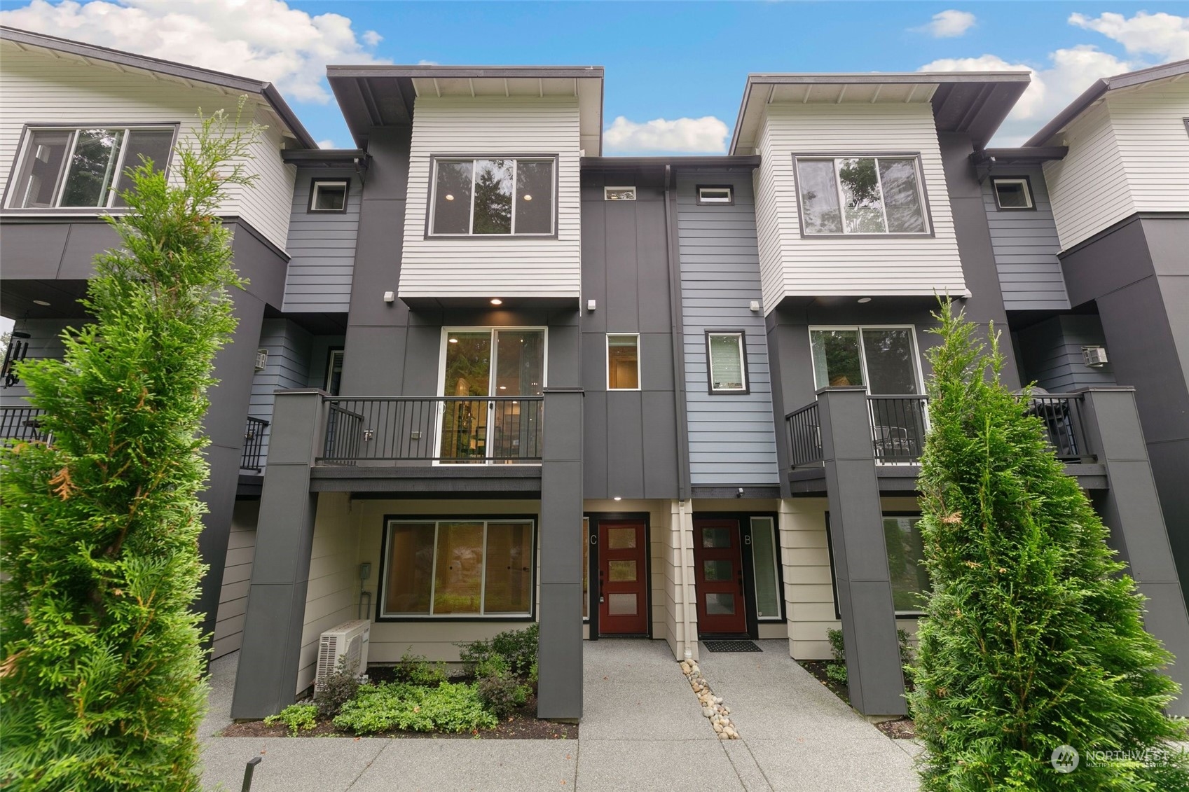 23626 5th Avenue Southeast, Unit C Bothell, WA 98021 - Photo 1 of 39 a front view of a house with a garden