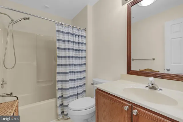 a bathroom with a sink toilet vanity and shower