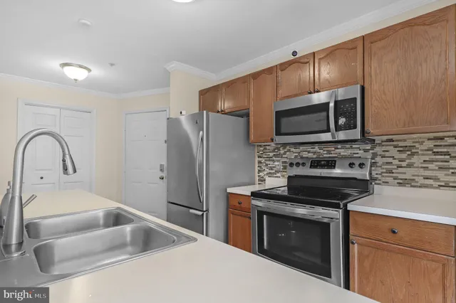a kitchen with a sink stove and refrigerator