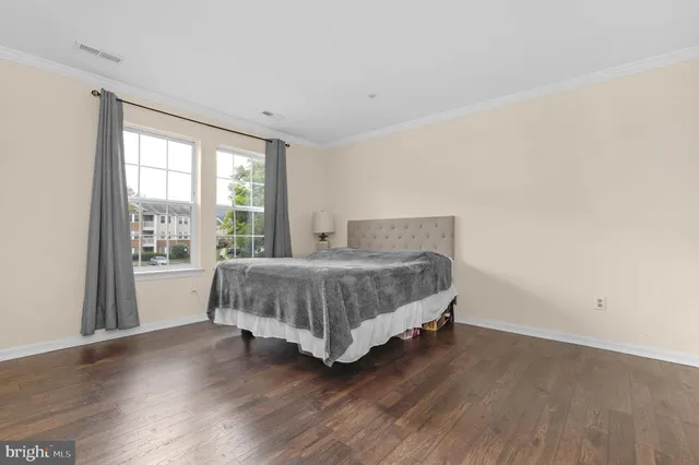 a bedroom with a bed and a large window